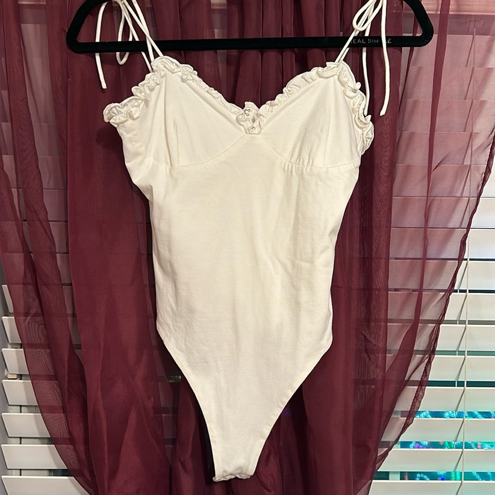 Superdown: white bow tie bodysuit